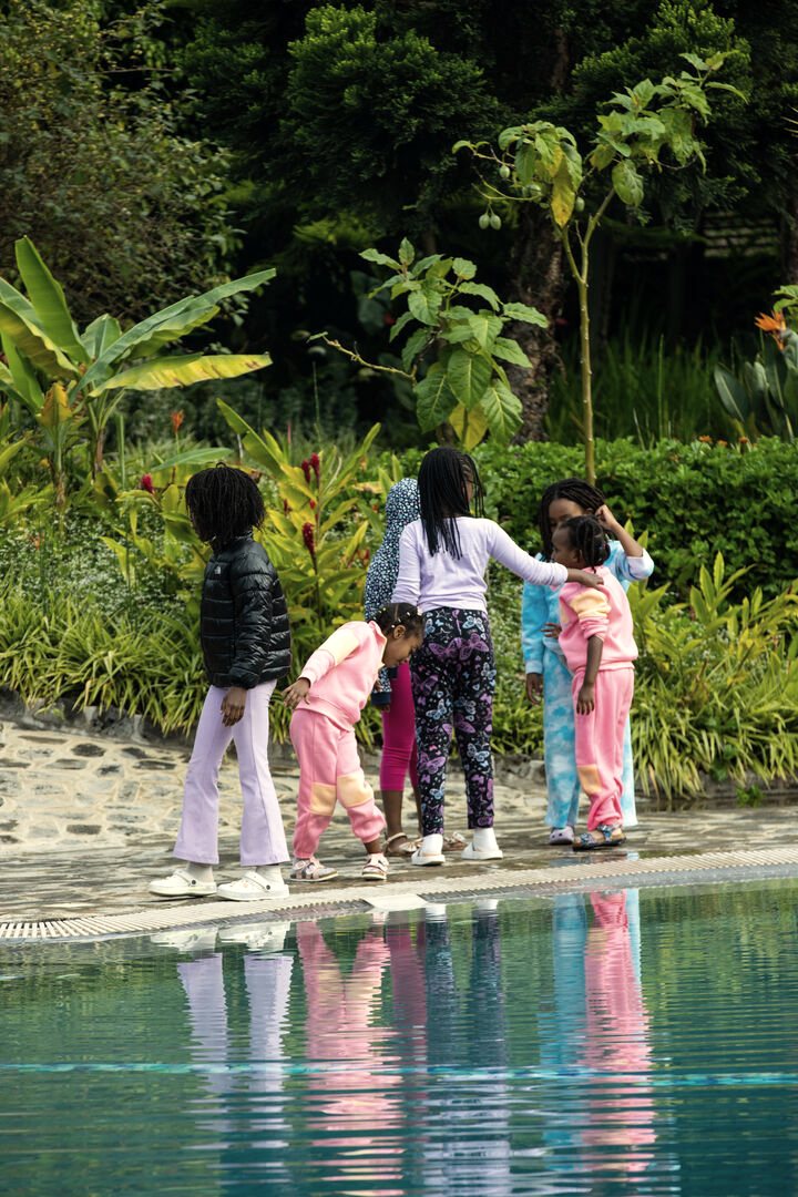 Children playing together beside the pool at Grotta Resort